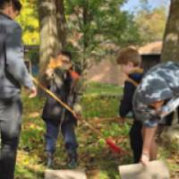 students installing bricks at Shawmut Hills sycamore circle mural site
